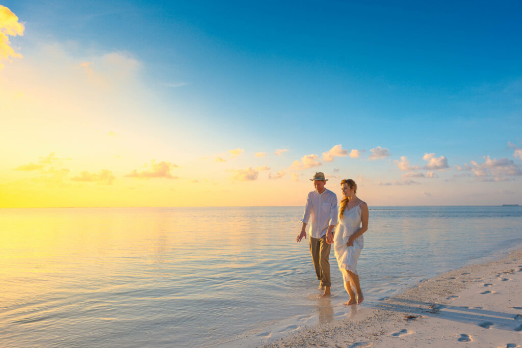 Serene Stroll: 4k Ultra HD Wallpaper of Couples Walking on Beach