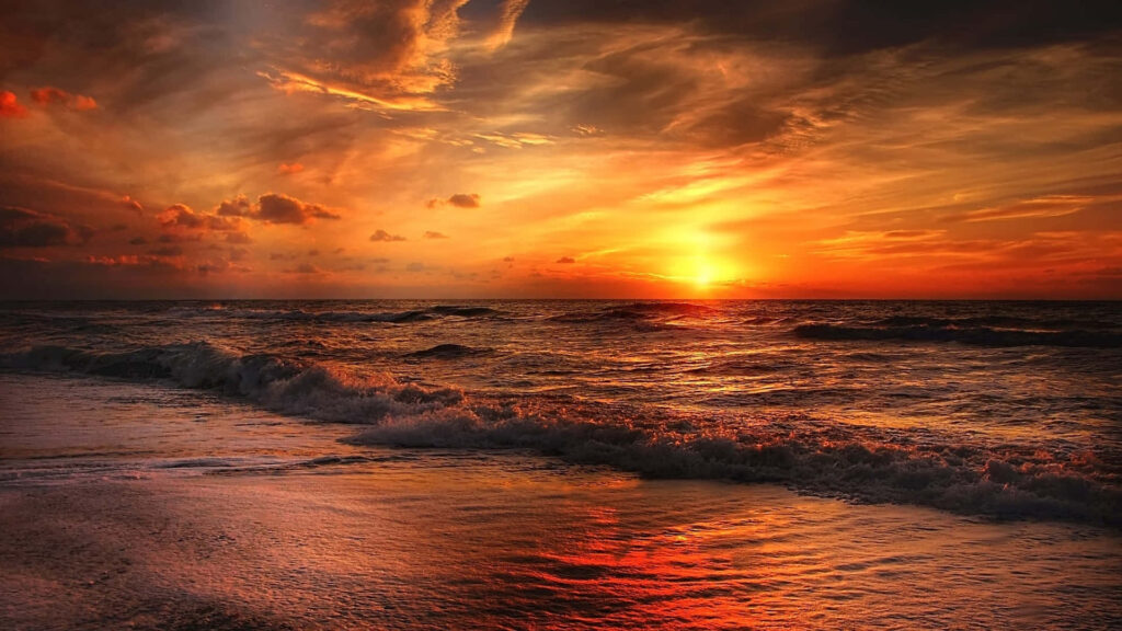Nature's Symphony: Waves Embrace Sunrise at Ocean Beach Wallpaper