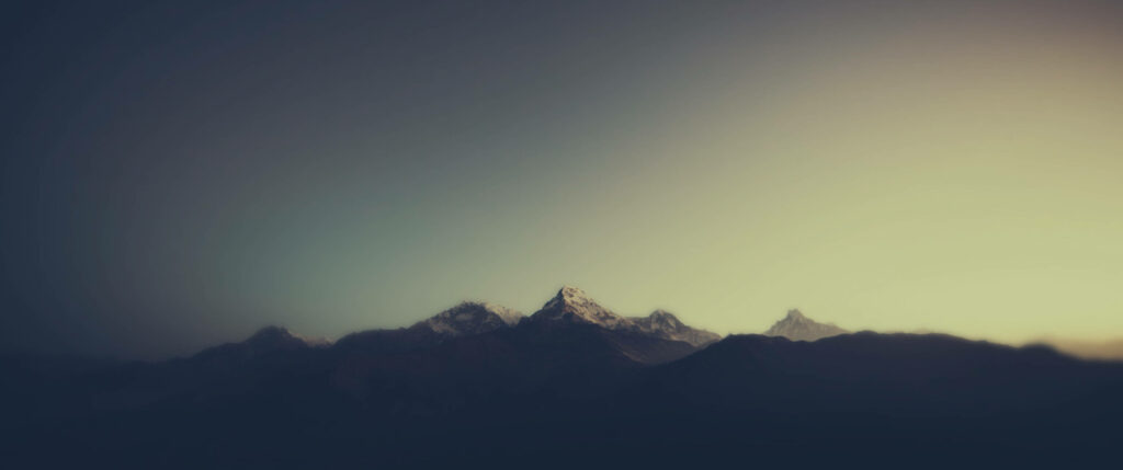 Serene Sunrise Minimalist Wallpaper: Mountain Range & Warm Light