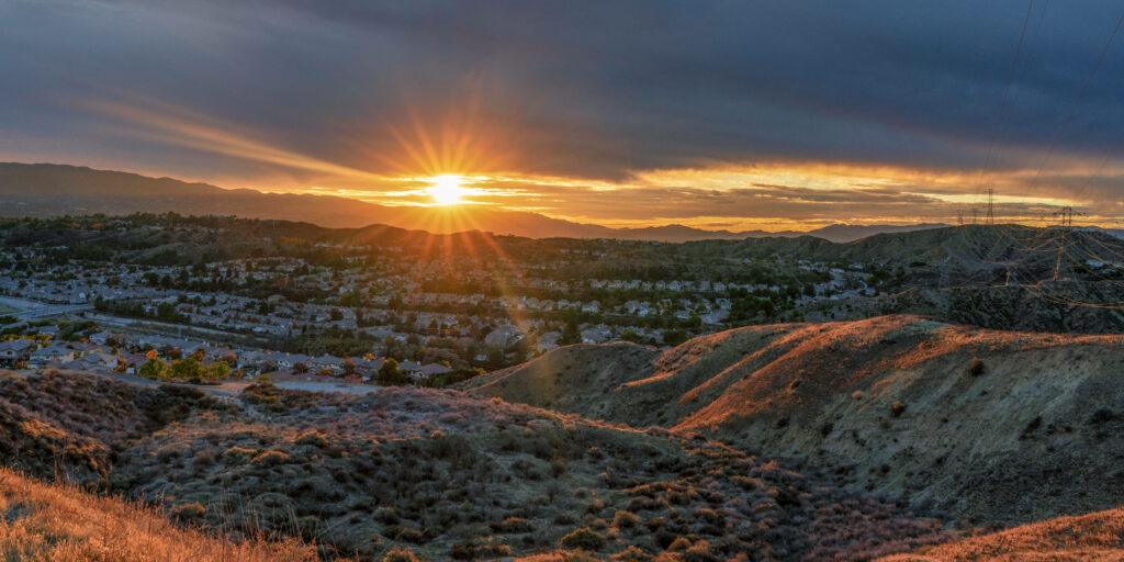 Serene Sunrise Wallpaper: Golden Rays Over Peaceful Hills