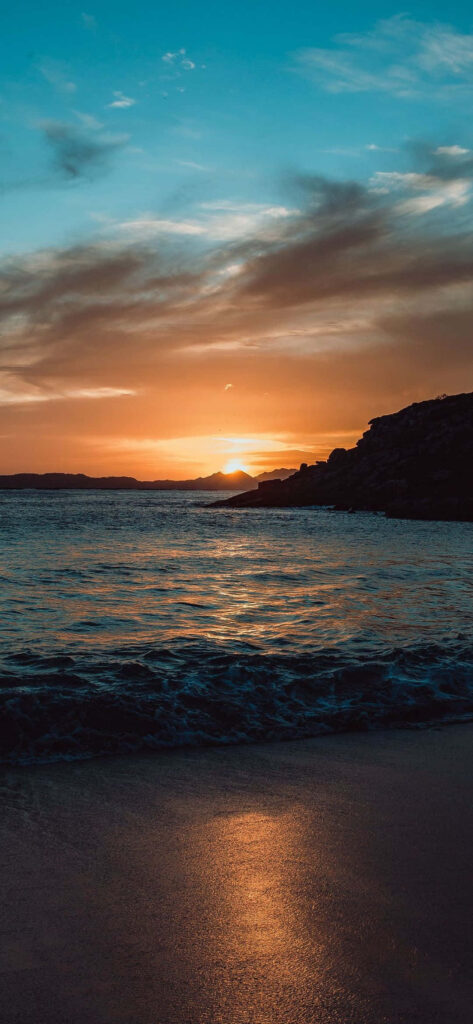 Serene Beach Sunset Wallpaper: Perfect Phone Background