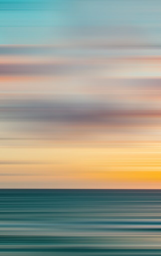 Serene sunset wallpaper with smooth gradient from soft blue to warm orange over horizon
