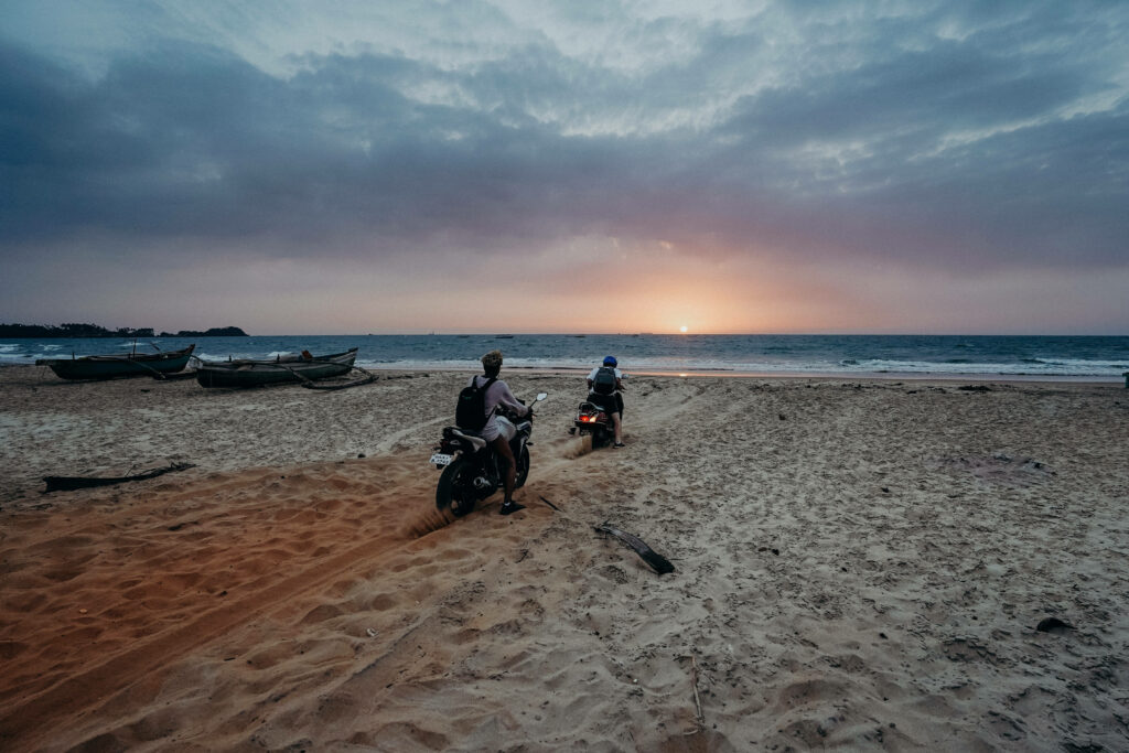 Tranquil Motorcycle Ride on Beach at Sunset - Serene Wallpaper
