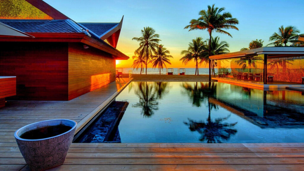 Tropical Serenity: A Sun-kissed Retreat with Palm Trees and Pool Wallpaper