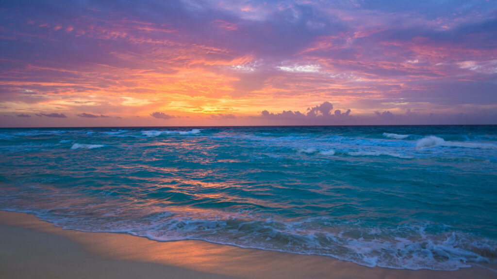 Serenity by the Shore: Mesmerizing Sunset Sky at Beach in 4k Resolution - Perfect Background for Your iPad Wallpaper