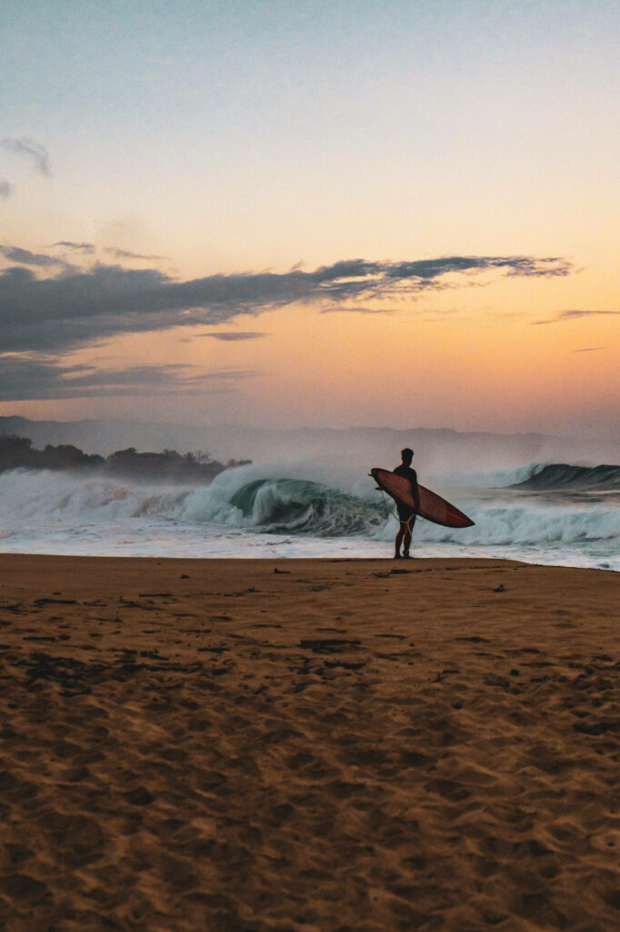 Lone Surfer at Sunset - Serene iPhone Wallpaper Background