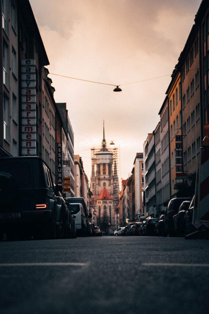 Serene Urban Sunset Wallpaper: Street, Cars & Cathedral Scene