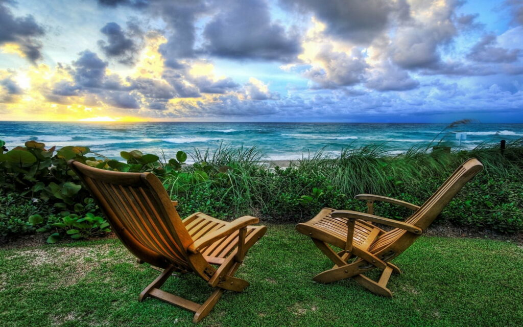 Solitude Serenade: Stunning HD Wallpaper of Empty Beach Chairs at Sunset