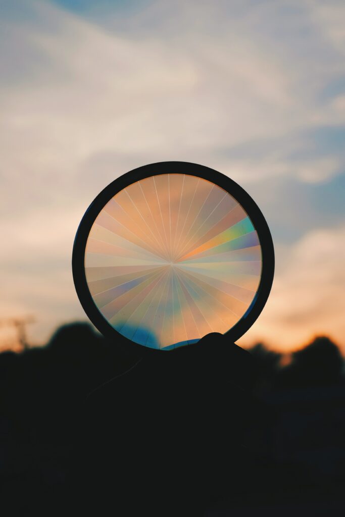 Serene Sunset Wallpaper: Circular Silhouette with Rainbow Pattern