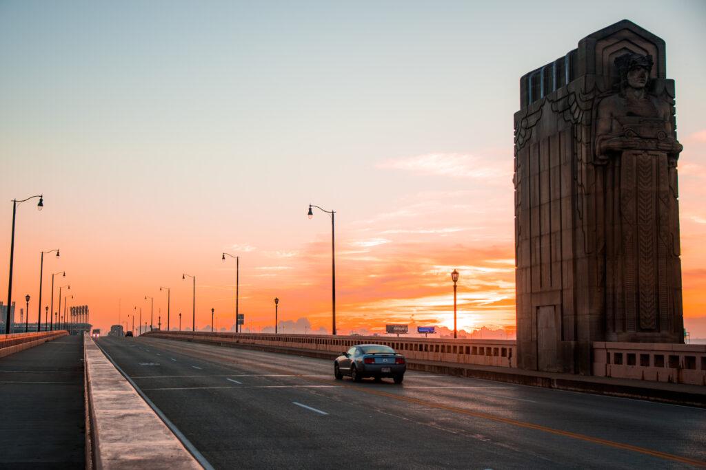 Serene Cleveland Sunset Wallpaper: Bridge and Car in Warm Hues