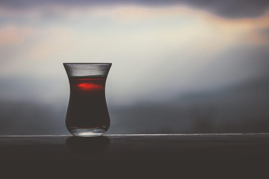 Serene Wallpaper: Glass of Tea with Moody Blurred Background