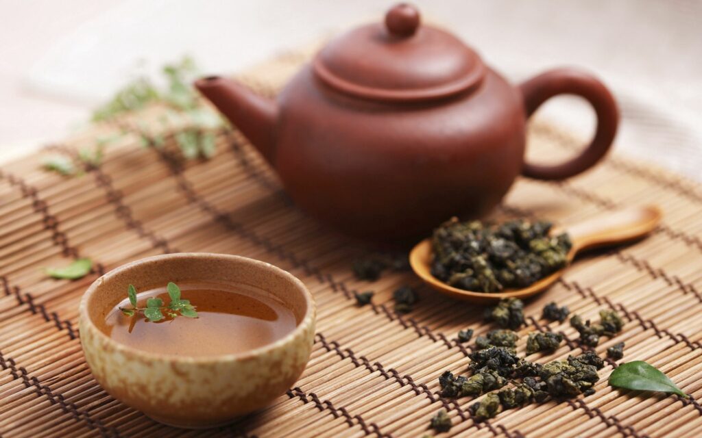 Serene Tea Time Wallpaper: Teapot, Cup & Loose Leaves on Bamboo