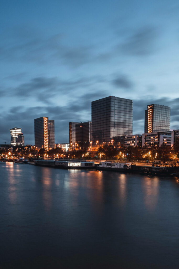 Serene Toledo Riverfront Evening: Modern Lights & Calming Reflections Wallpaper