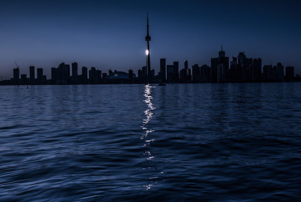 Serene Nighttime Toronto Skyline Wallpaper with Moonlit Reflection