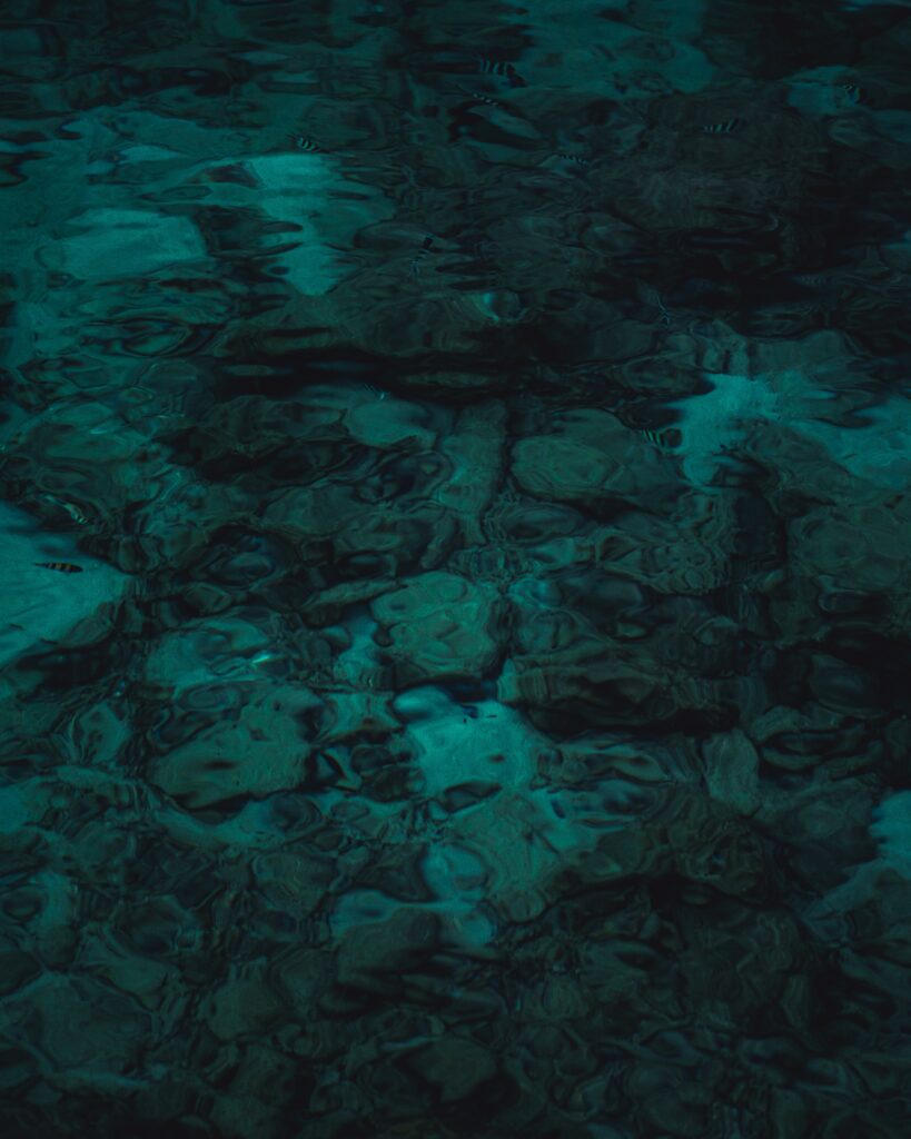 Serene transparent blue water wallpaper with gentle ripples and calming underwater textures