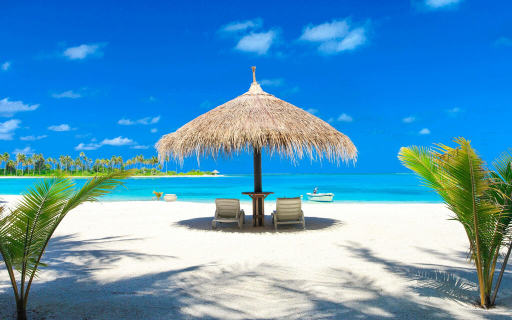 Serene Beach Desktop Wallpaper with Thatched Umbrella & Lounge Chairs