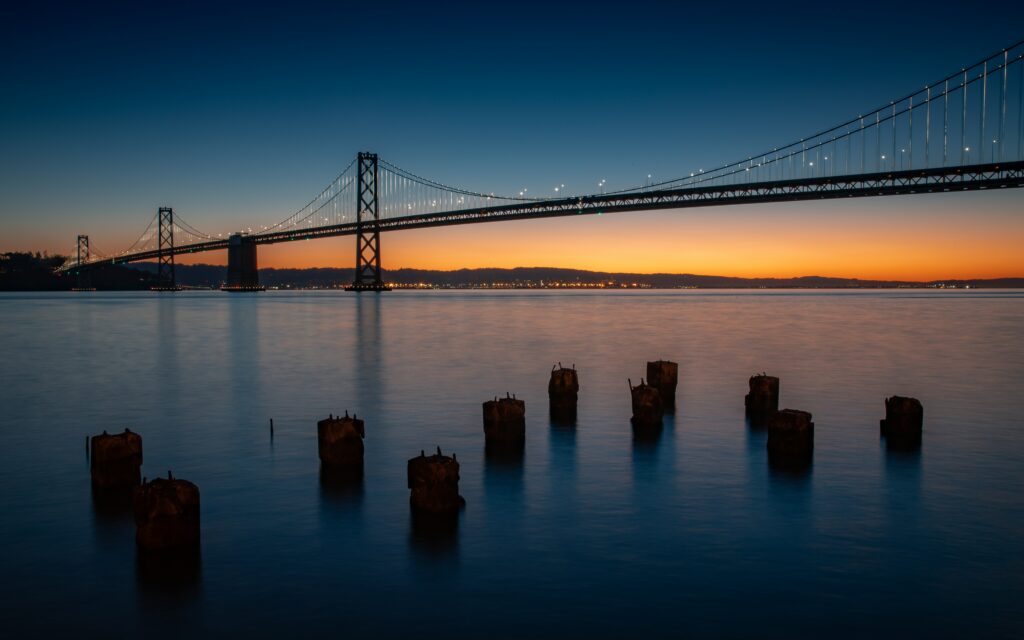 Serene Twilight Wallpaper: Bridge Reflection Over Calm River