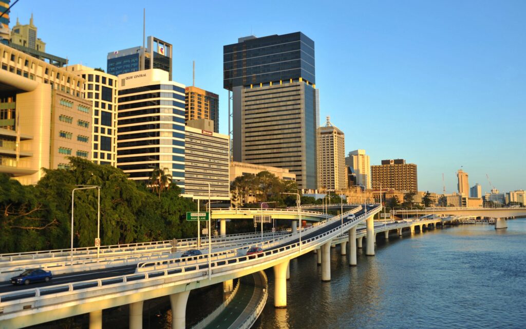 Scenic Urban Bridge Wallpaper: Vibrant City & Calm Waters