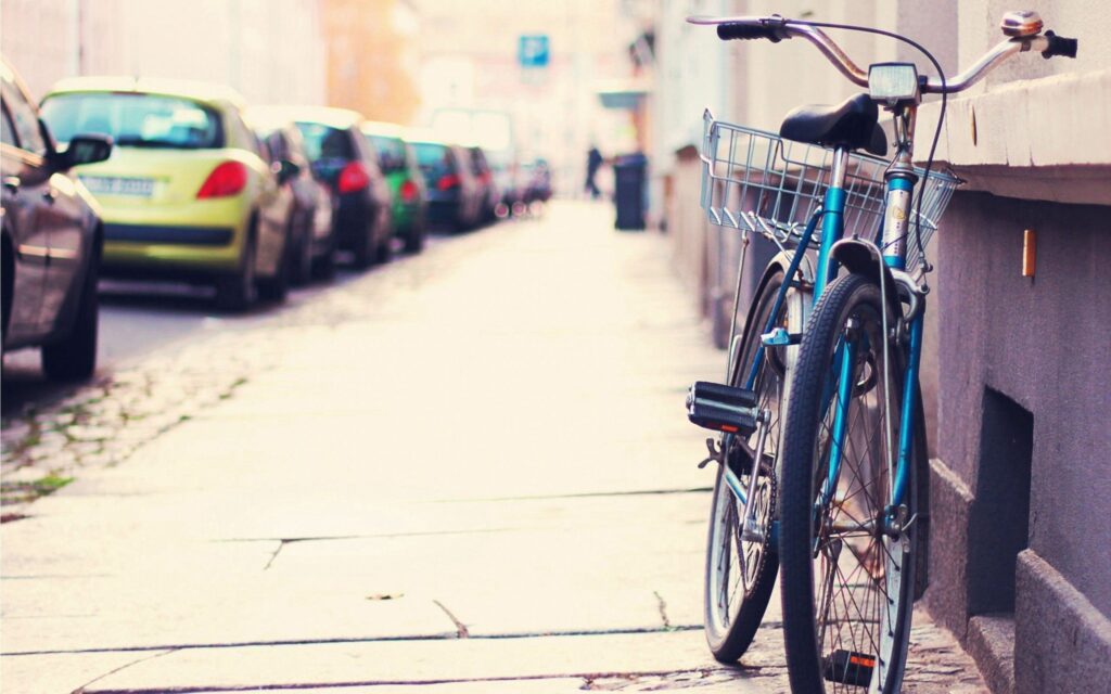 Tranquil Urban Street: Blue Bicycle on Sidewalk - Wallpaper Background