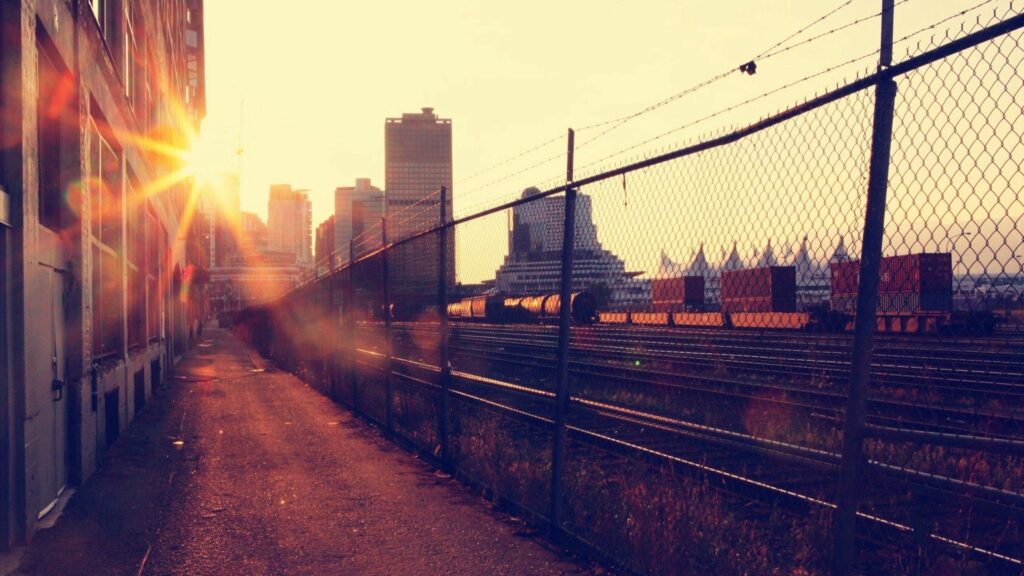 Serene Urban Sunset Wallpaper: Golden Rays & Industrial Charm