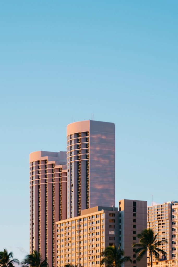 Serene Urban Wallpaper: Modern High-Rise Buildings & Palm Trees