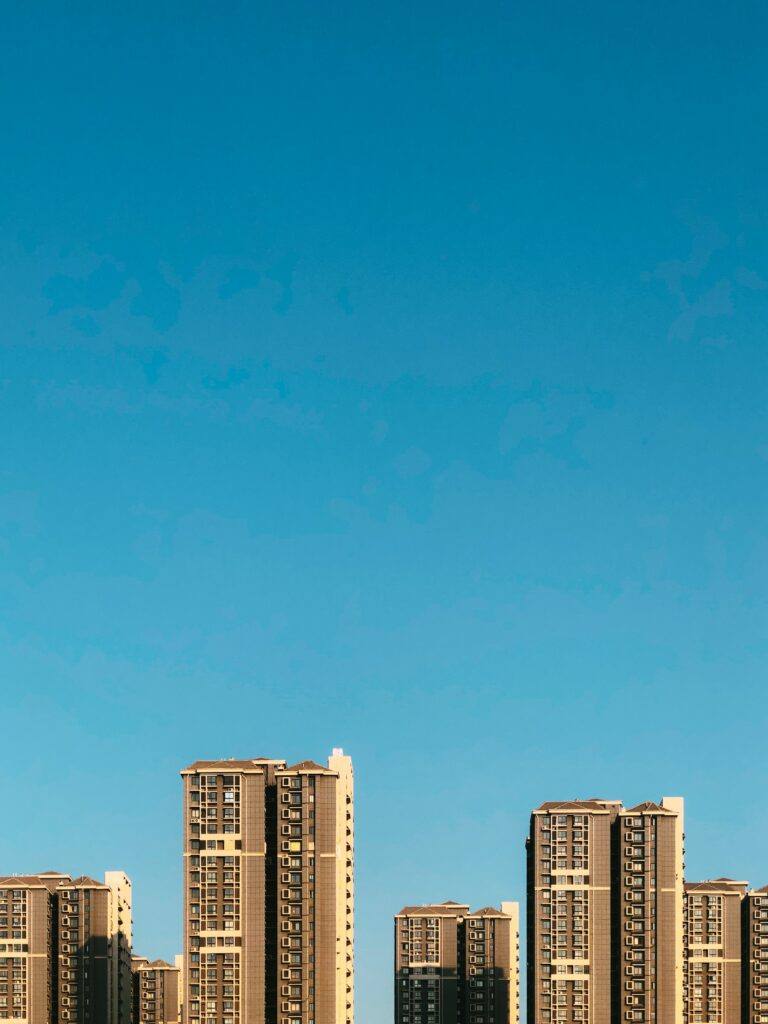 Modern Urban Architecture Wallpaper: High-Rise Buildings & Blue Sky