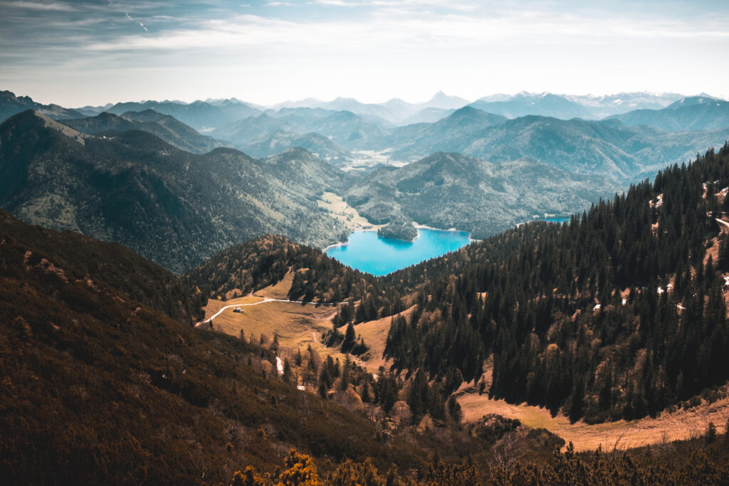 Walchensee lake blue waters surrounded by pine forests and alpine mountains cloudy sky wallpaper