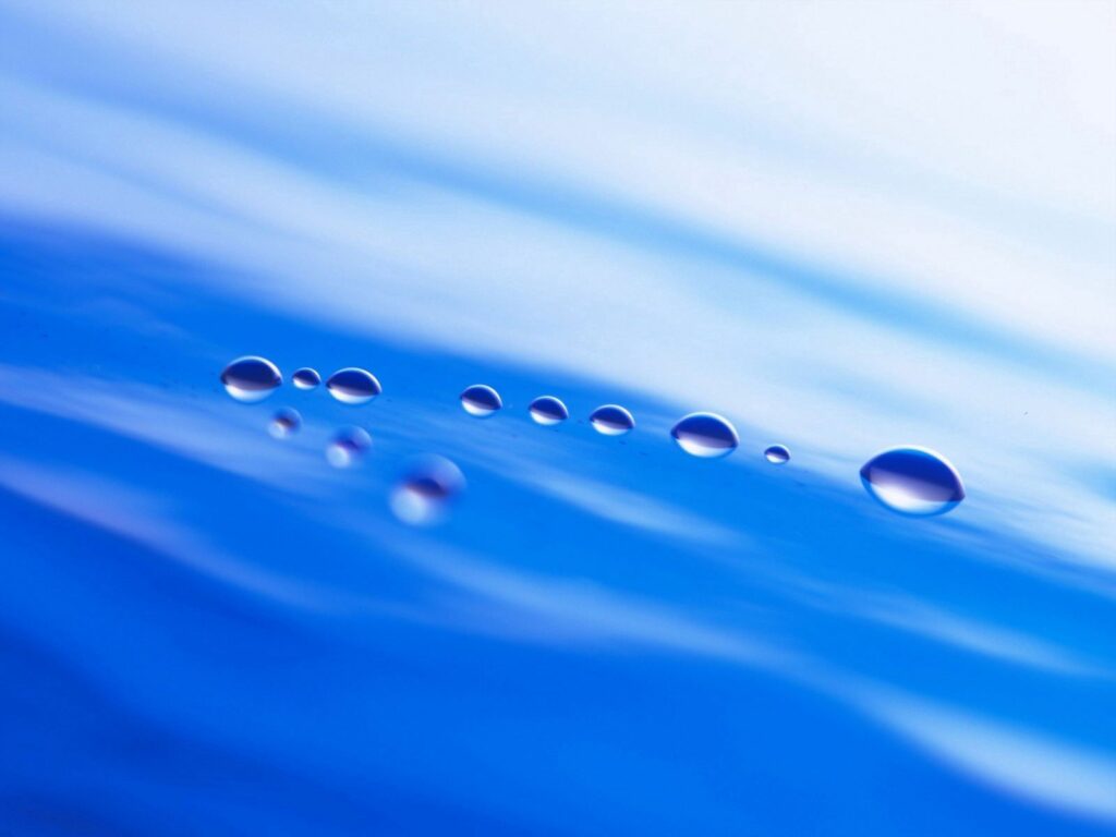 Serene Wallpaper: Delicate Droplets on Soft Blue Background
