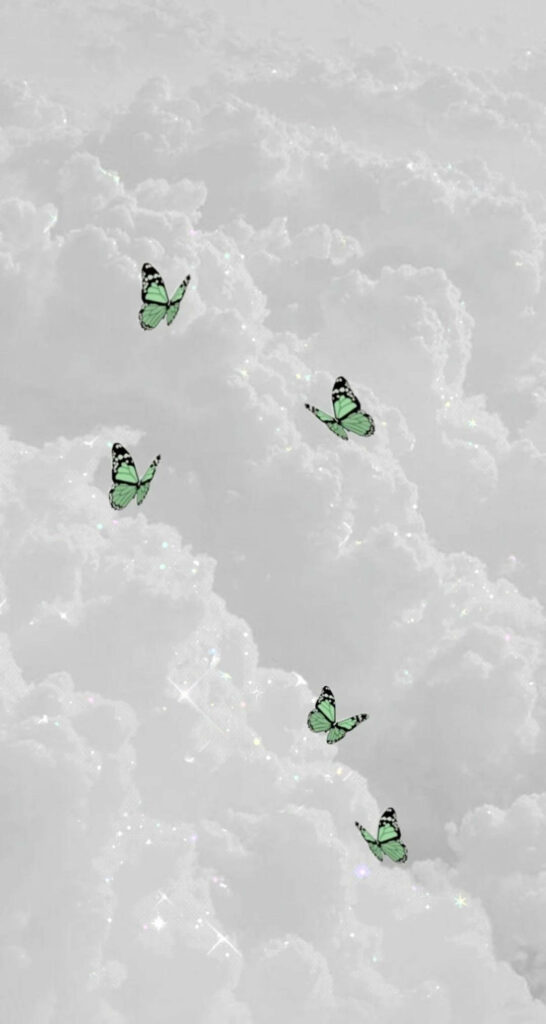 Serene Green Butterfly Wallpaper Over Dreamy White Clouds