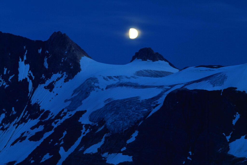 Radiant Full Moon Over Snowy Peaks - Serene Wallpaper Background