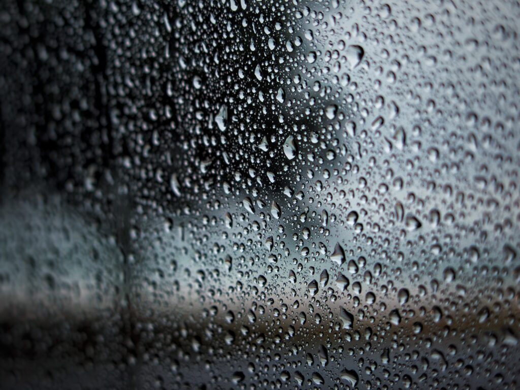 Serene Water Droplets Wallpaper: Close-Up on Glass Surface