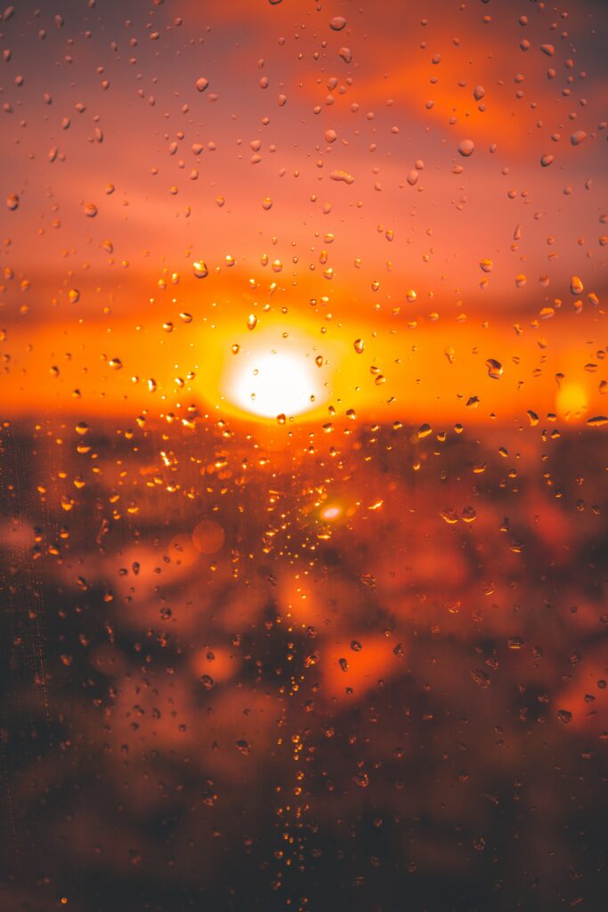 Serene Water Droplets Wallpaper: Sunlit Glass Surface Background