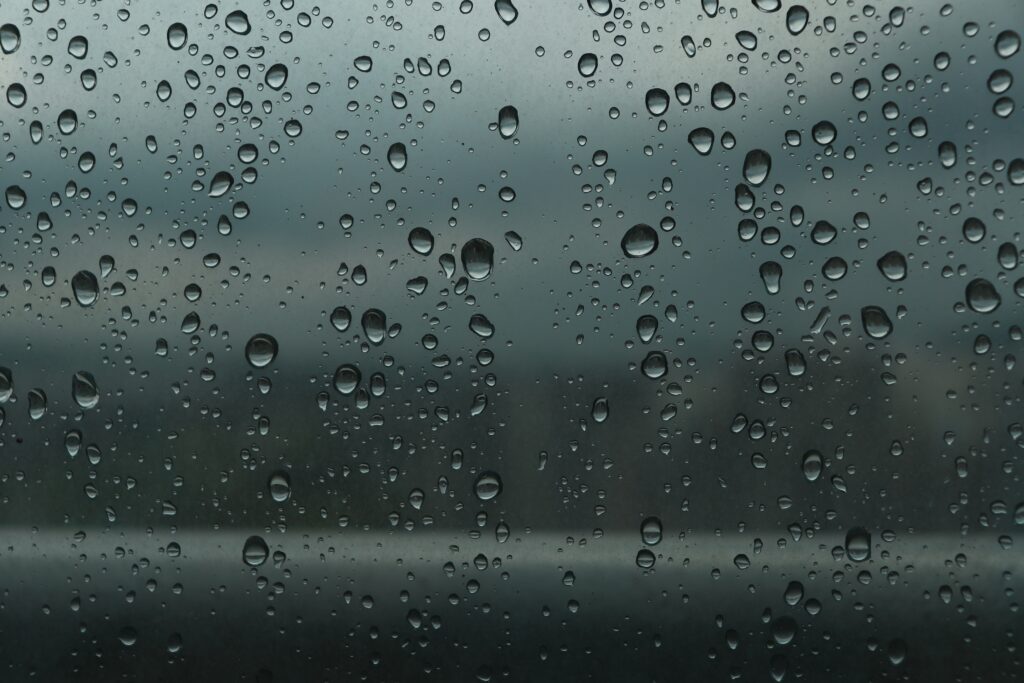Serene Water Drops Wallpaper: Calming Glass Surface Background