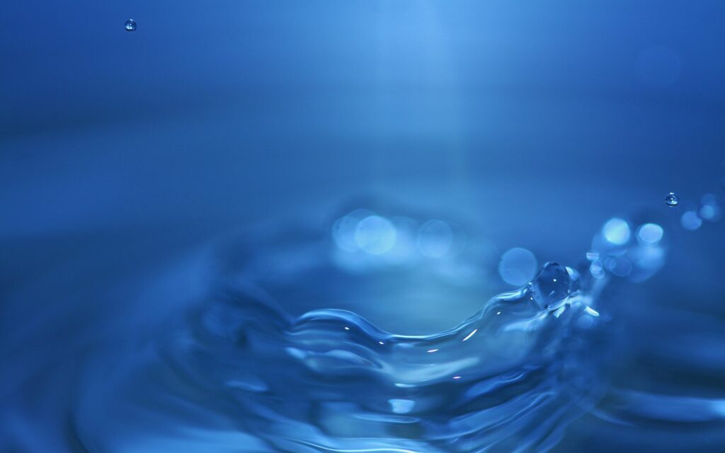 Serene Blue Water Wallpaper: Close-Up Splash & Rippling Circles