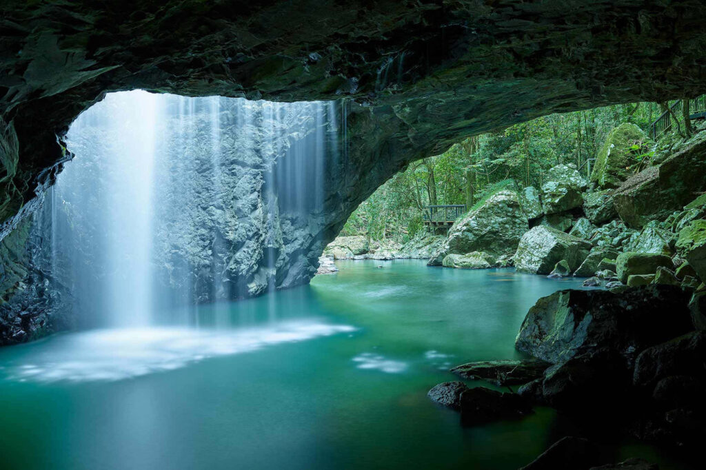 Serene Waterfall in Lush Forest: A Tranquil Nature Escape Wallpaper