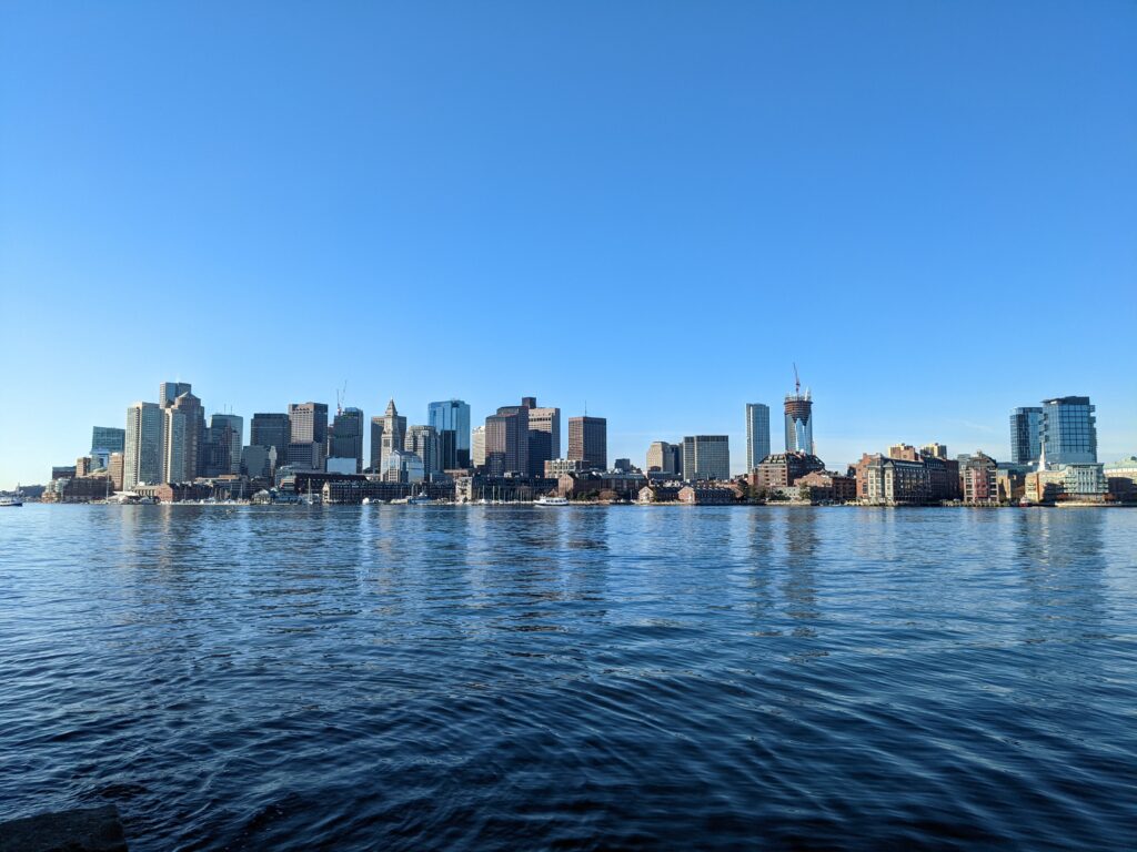 Modern Waterfront Cityscape Wallpaper: Serene Architecture Reflection
