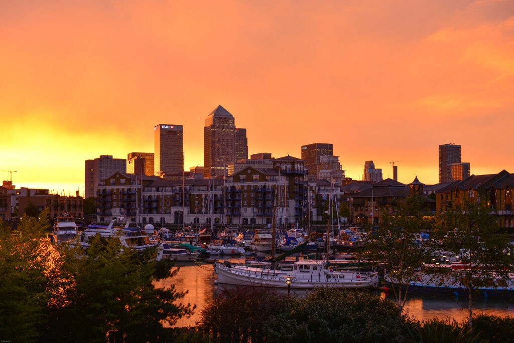 Serene Waterfront Sunset Wallpaper: Yachts & Modern Harbor View