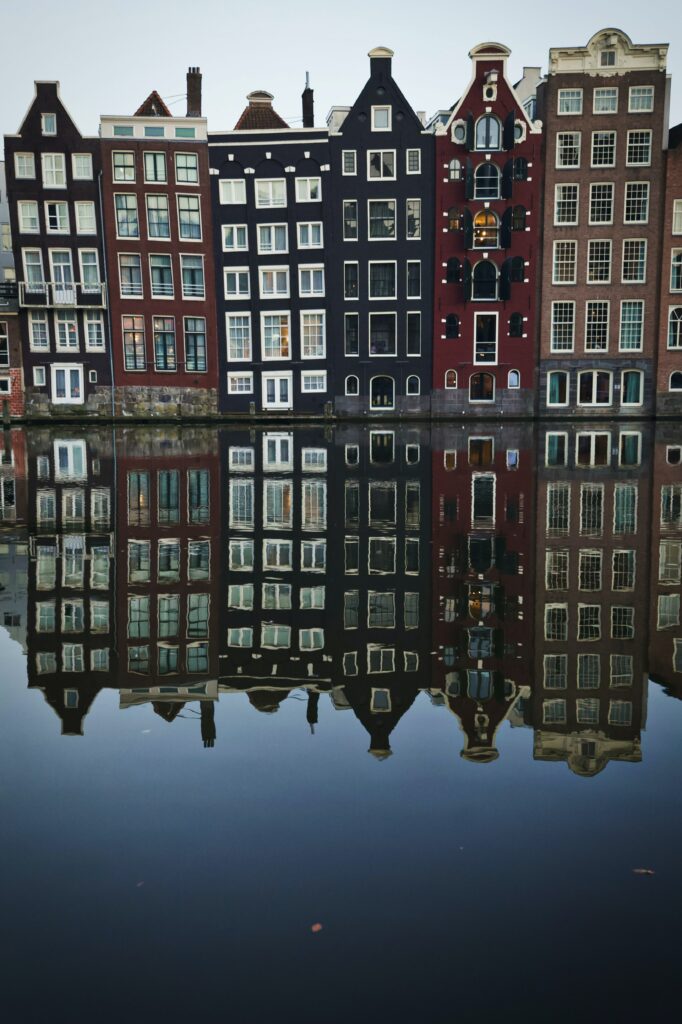 Serene Waterfront Wallpaper: Colorful Houses Reflected on Water