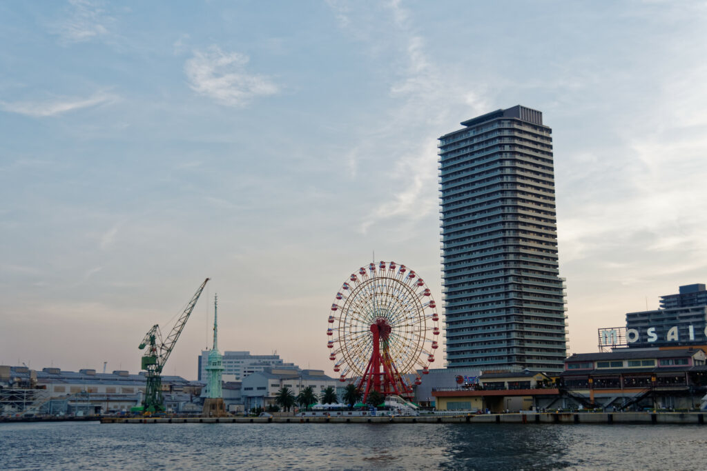 Tranquil Waterfront Wallpaper: Red Ferris Wheel & City Reflections