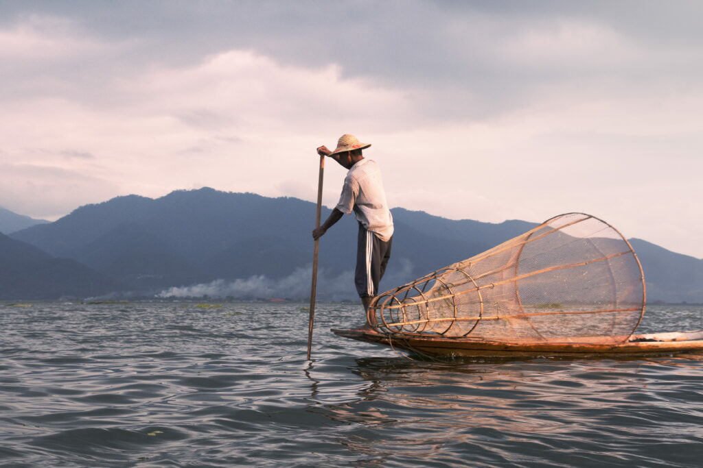 Riverside Adventure: Serene Fisherman in Action - 4K Wallpaper