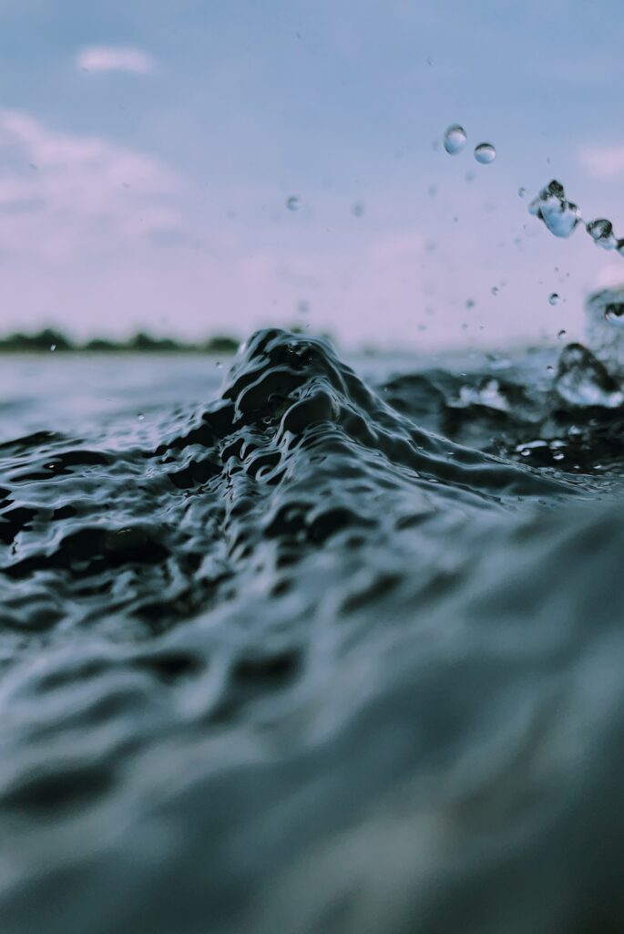 Serene Wave Close-Up: Detailed Ripples & Splashes Wallpaper