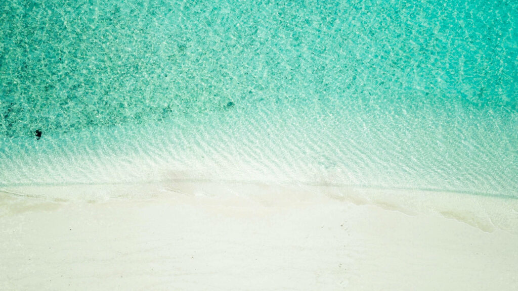 Serene White Sandy Beach & Sparkly Turquoise Waters Background Wallpaper