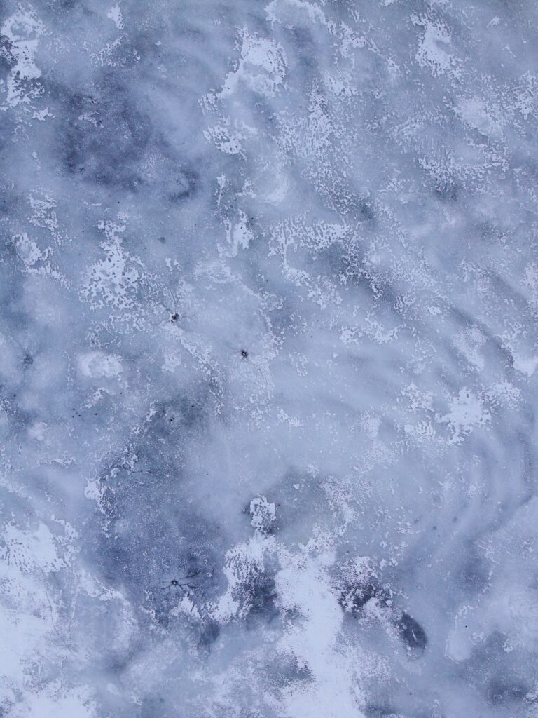 Icy winter landscape wallpaper with textured snow ice floes in blue gray and white tones
