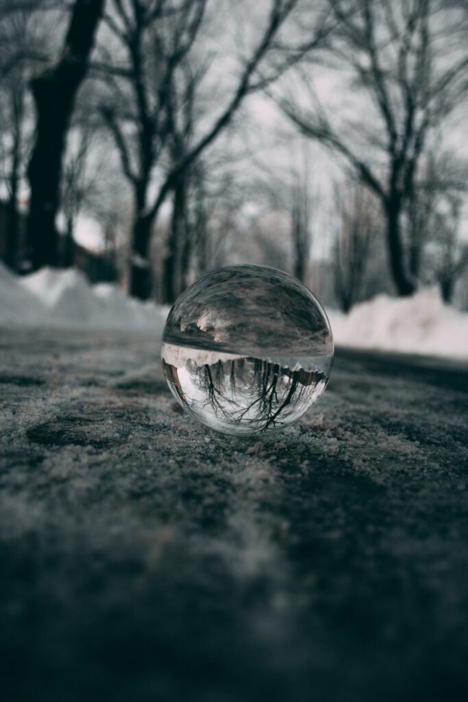 Winter Serenity: Glass Ball Reflects Snowy Landscape - Wallpaper
