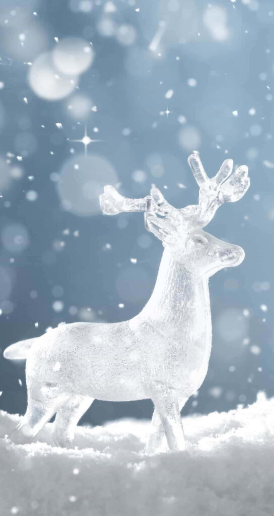 Serene Winter Scene: Glass Reindeer in Snowy Holiday Wonderland Wallpaper