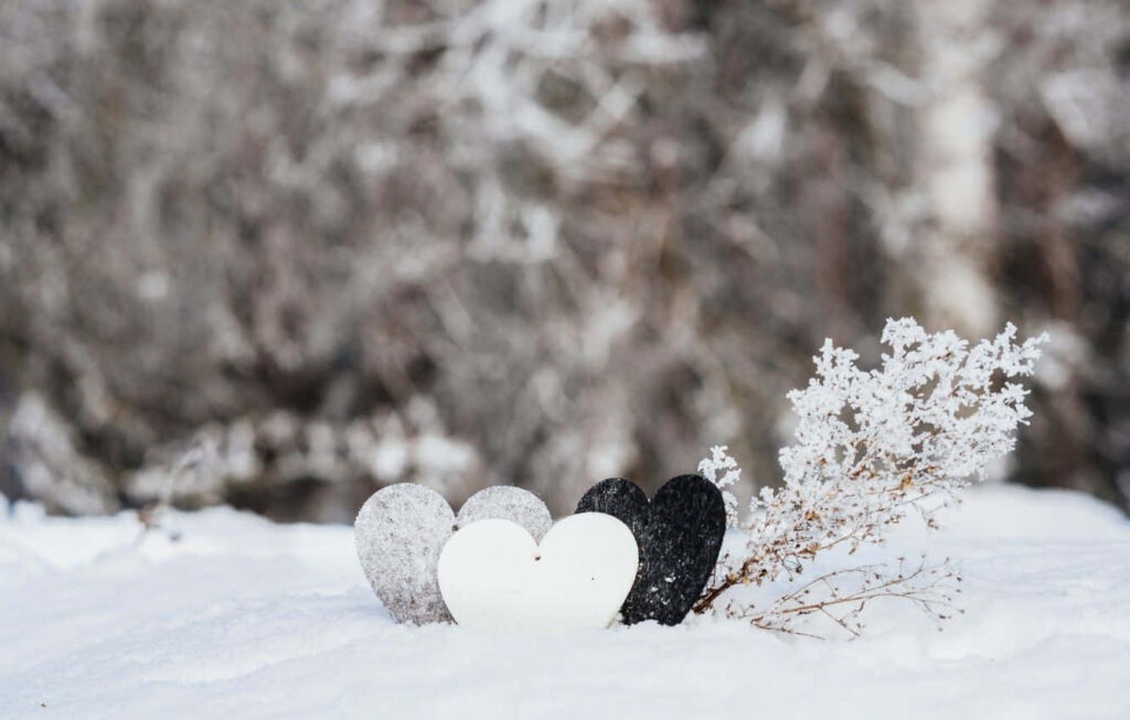 Serene Winter Wallpaper: Heart-Shaped Objects on Pristine Snow