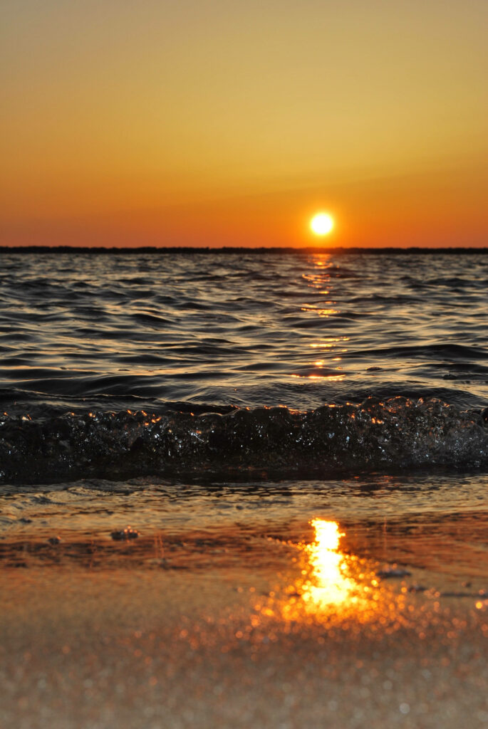 Serene Yellow Sunset Wallpaper: Soothing Ocean & Beach Background