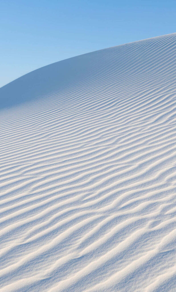 Serene iPhone Wallpaper: Rippled White Sand Dunes & Clear Blue Sky