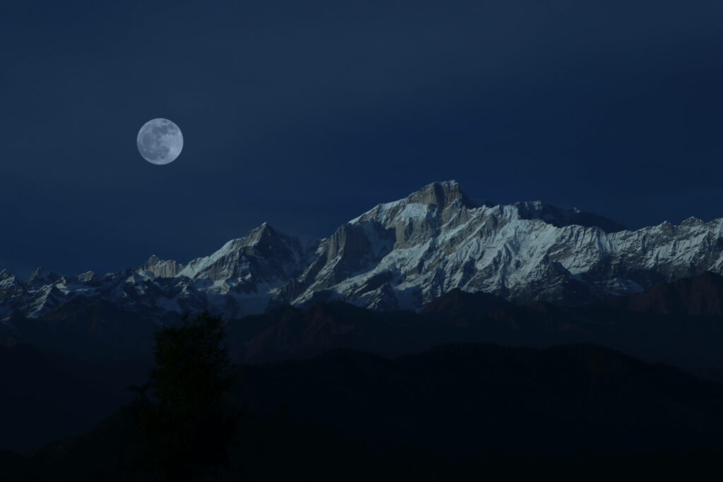 Majestic Winter Night: Full Moon Illuminating Snow-capped Peaks Wallpaper