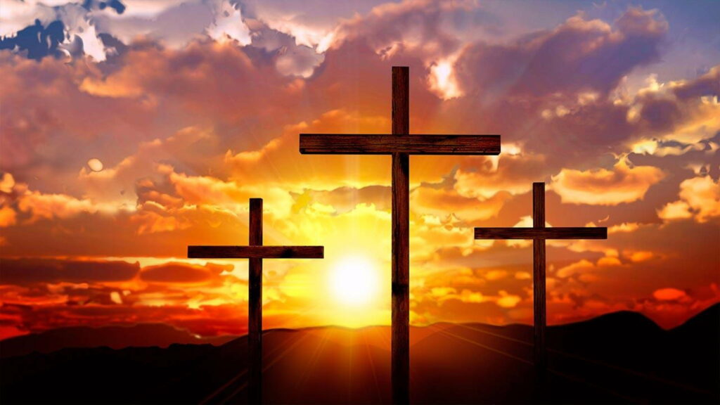 Divine Serenity: Majestic Crosses Illuminated by the Setting Sun Wallpaper